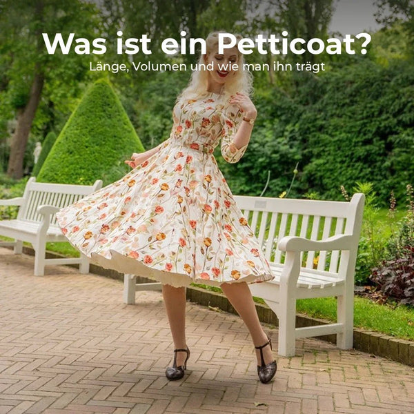 Frau im geblümten Swingkleid der 1950er Jahre dreht sich, darunter blitzt der Petticoat hervor